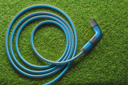 a qwickhose hosepipe lying on a lawn